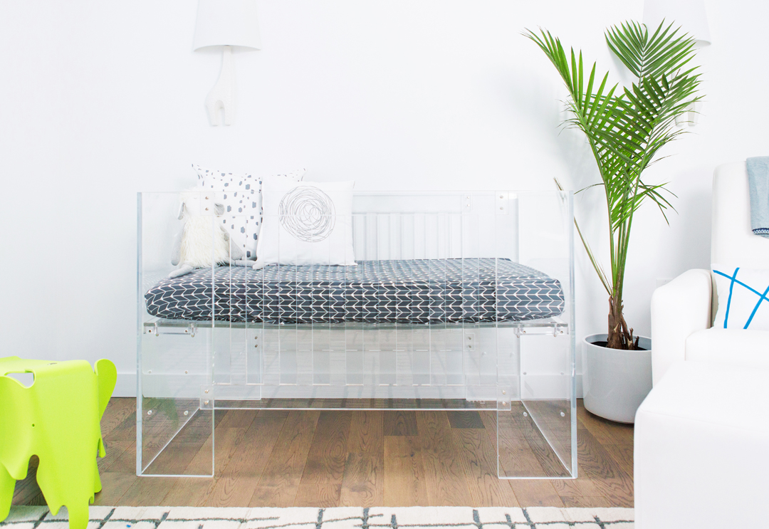 Acrylic crib in modern nursery by Little Crown Interiors