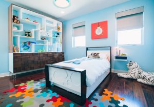 Boy's bedroom with large tiger stuffed animal by Little Crown Interiors